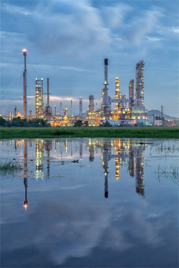 An industrial processing facility illuminated at dusk