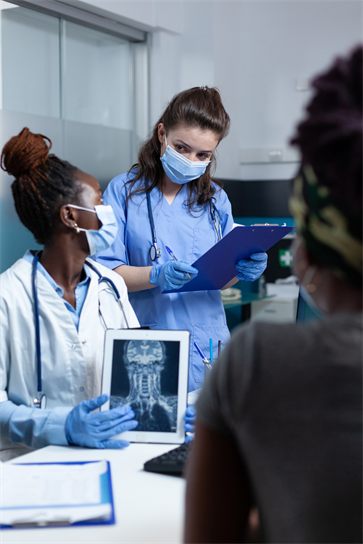 Medical staff reviewing a diagnostic scan in a clinical setting